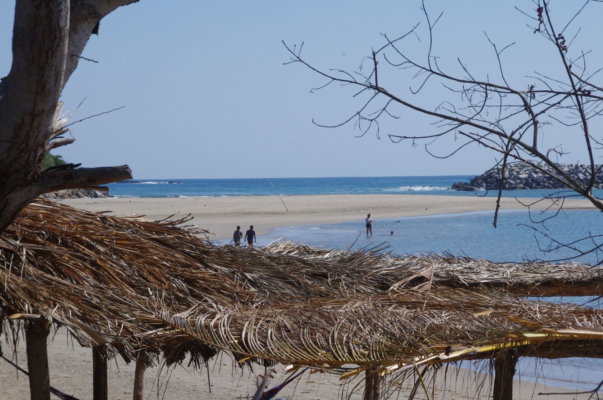 Quiet bay beach on the Oaxacan coast under a palapa